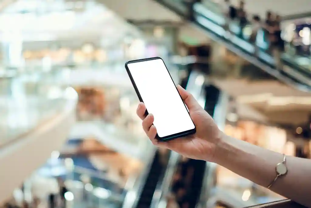 photo of woman's hand holding cellphone in a mall