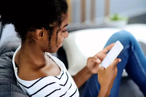 photo of young woman relaxing with smartphone