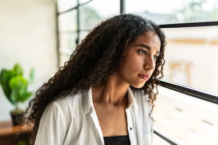 photo of woman looking out window