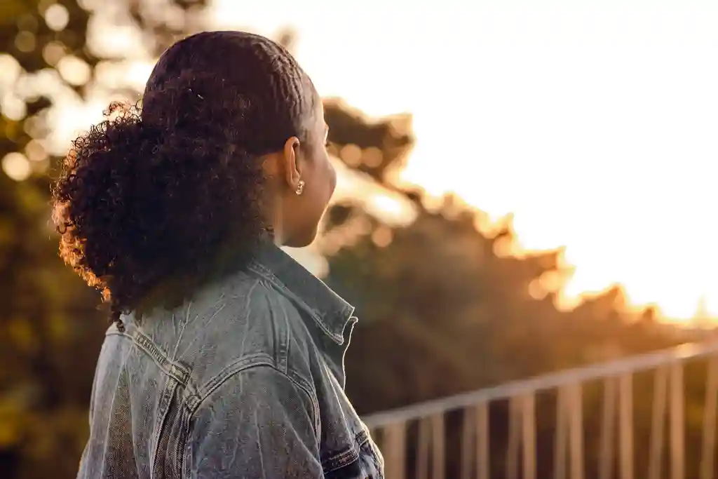 photo of young woman looking at the view