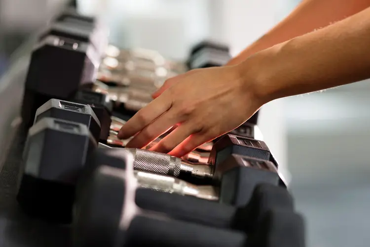 photo of reaching for hand weights