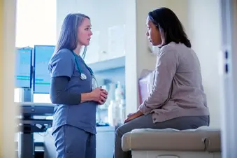 photo of doctor talking to patient