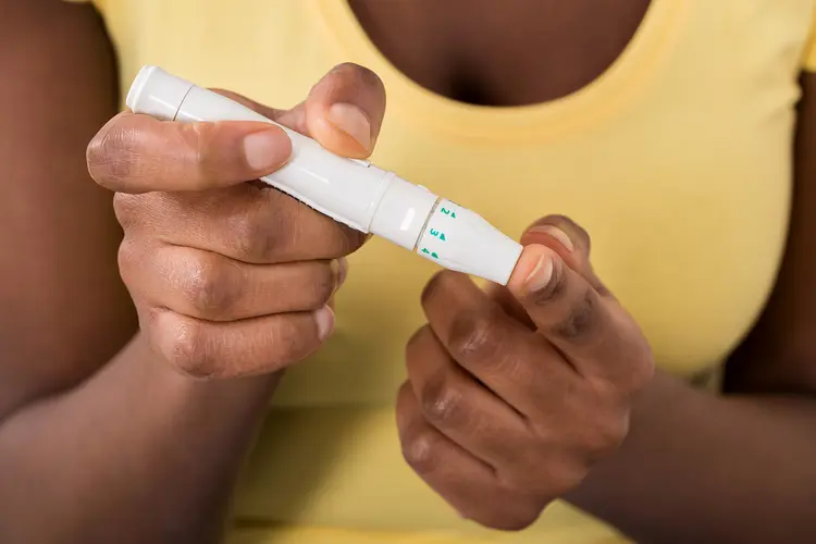 photo of woman using glucometer