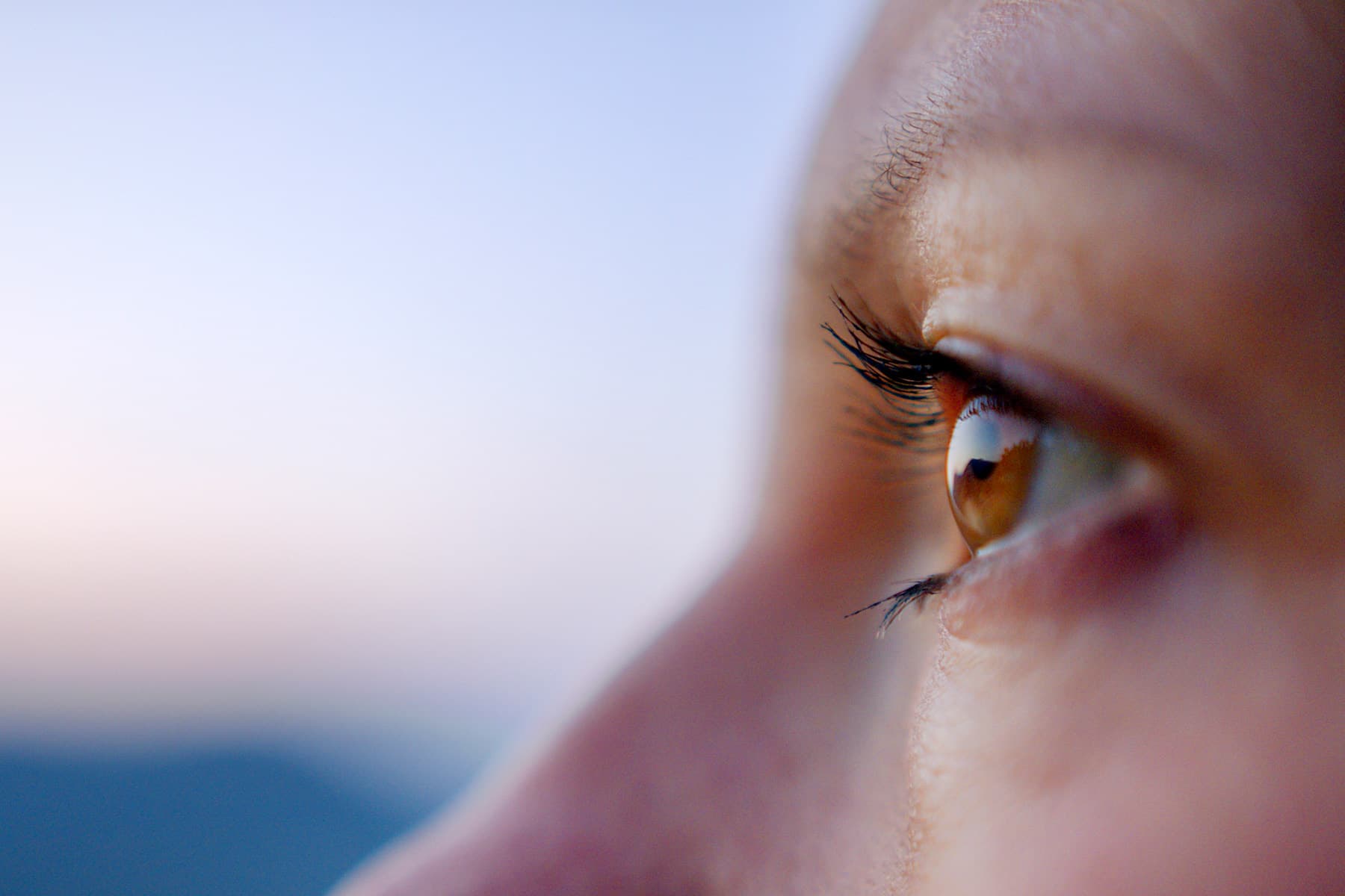 photo of young woman looks out to view lakeshore