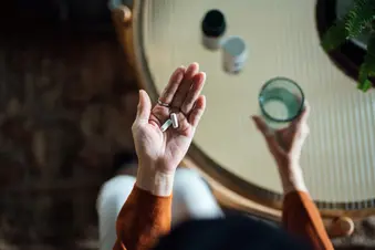 photo of woman taking pills