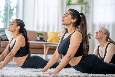 photo of women doing yoga at home