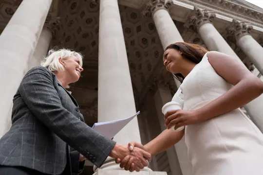 photo of businesswomen closing deal with handshake