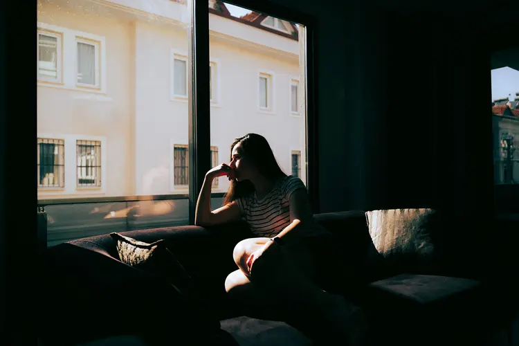 A photo of woman looking out window