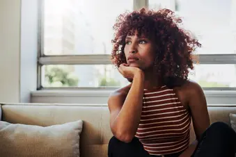 photo of depressed woman sitting on sofa