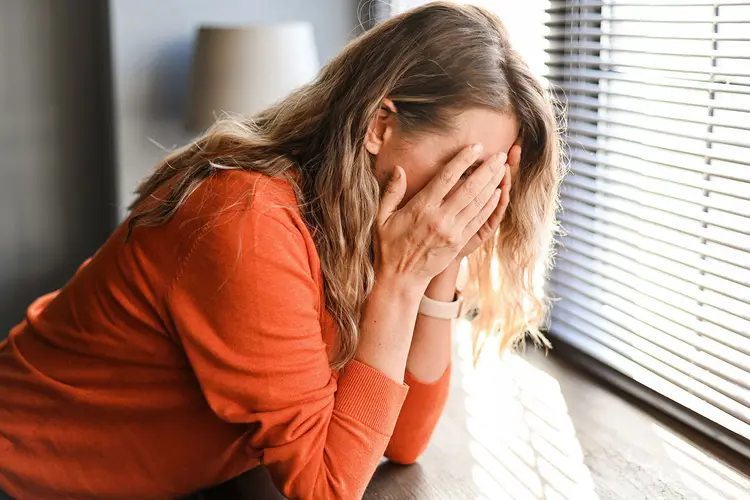 photo of adult woman with hands over face
