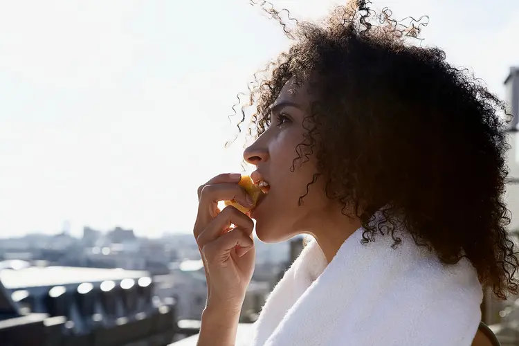 photo of woman eating apple