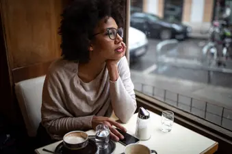 photo of young woman in cafe thinking