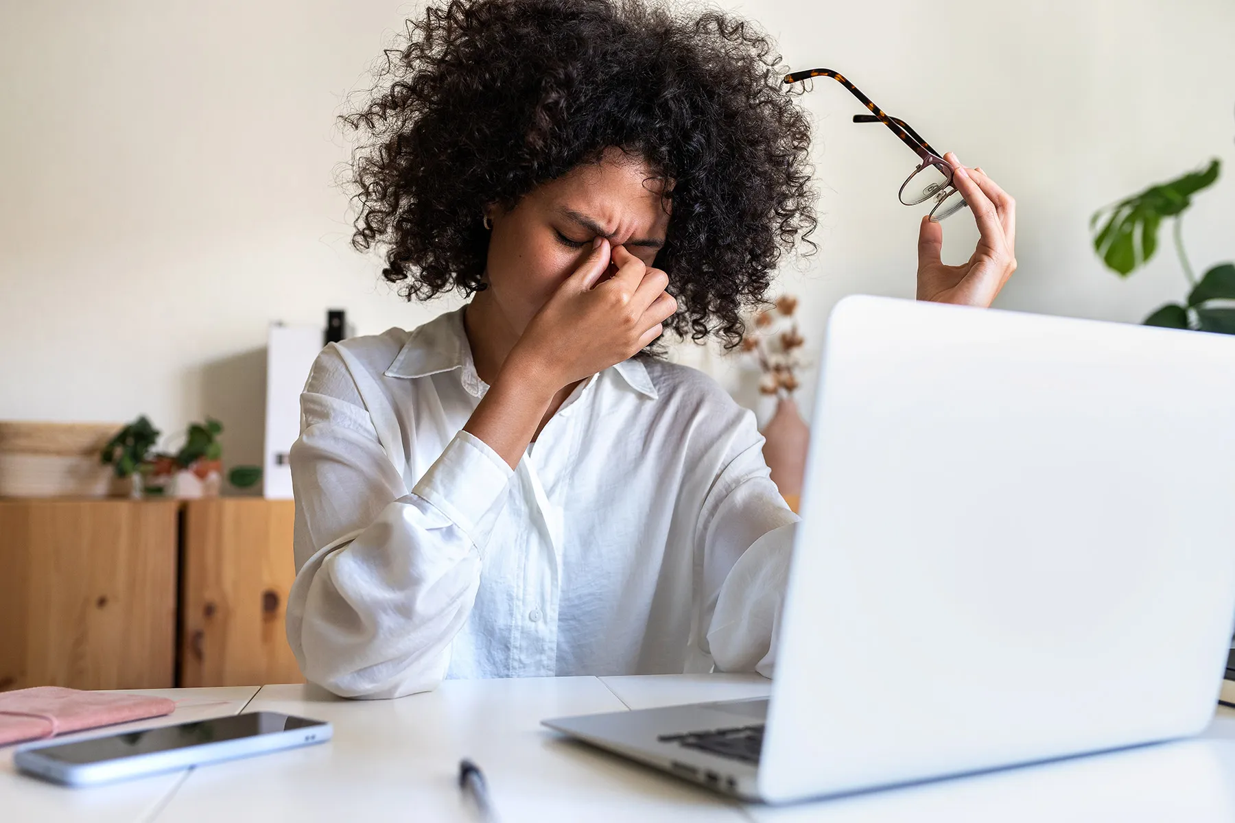 photo of tired, young woman at office desk