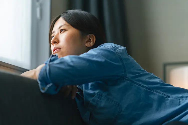 photo of woman looking out window