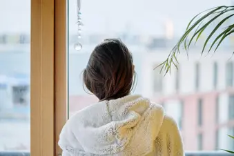 photo of woman looking out window