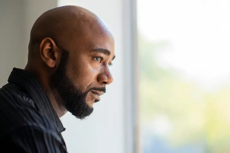 photo of man looking out window