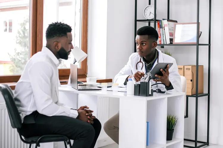 photo of doctor talking with male patient