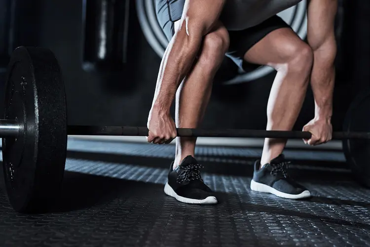 photo of man lifting weights