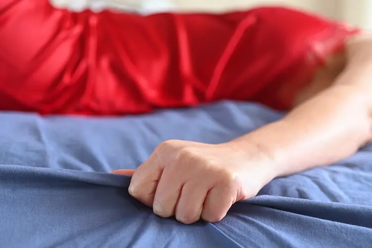 photo of woman experiencing orgasm in bed