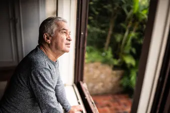 photo of hispanic man looking out window