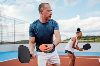 photo of doubles playing pickelball