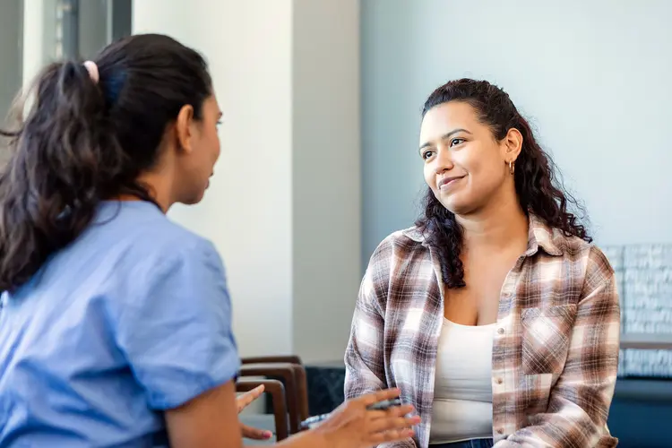 photo of female patient talking with doctor