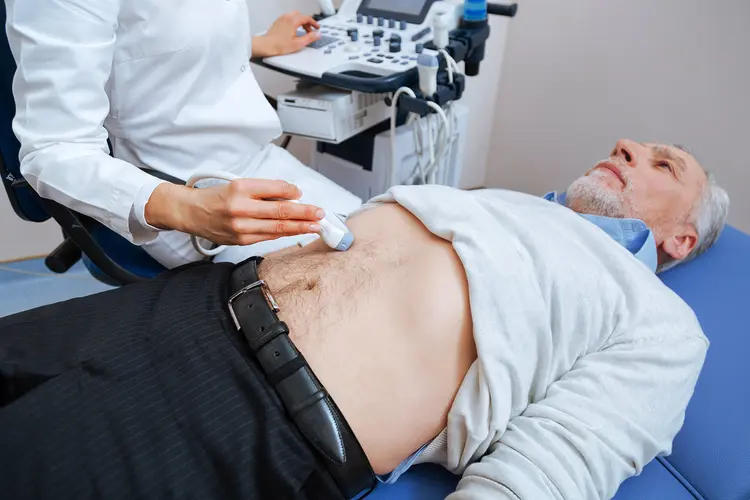 photo of senior man receiving abdominal ultrasound