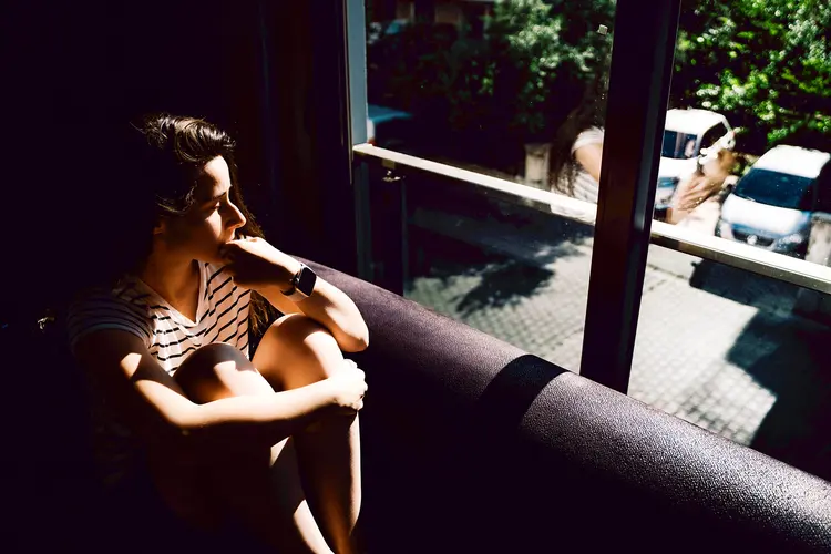 Photo of unhappy woman looking out window