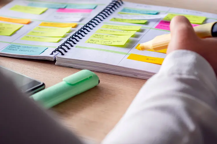 photo of checking post-it notes in calendar