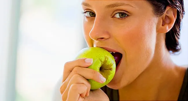 woman biting apple
