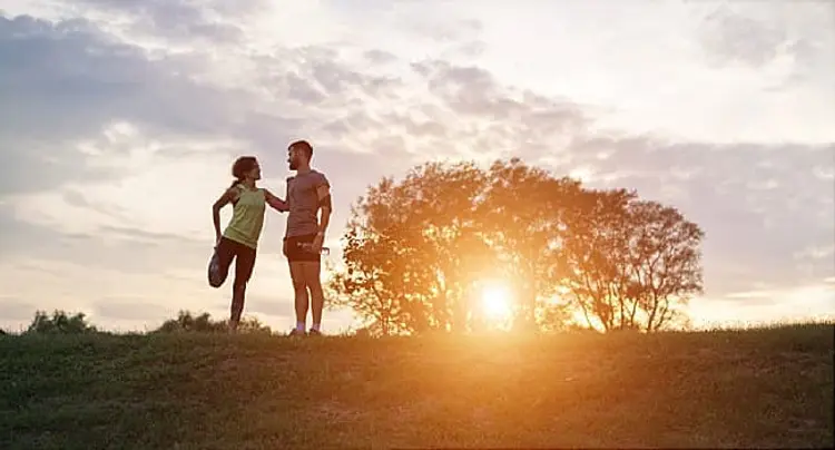 couple_stretching_in_field
