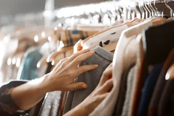 photo of woman looking through clothes