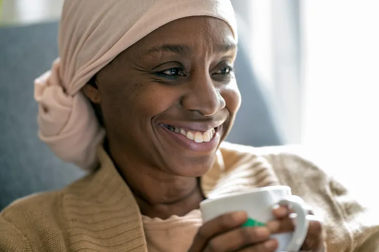 photo of woman with headwrap drinking tea