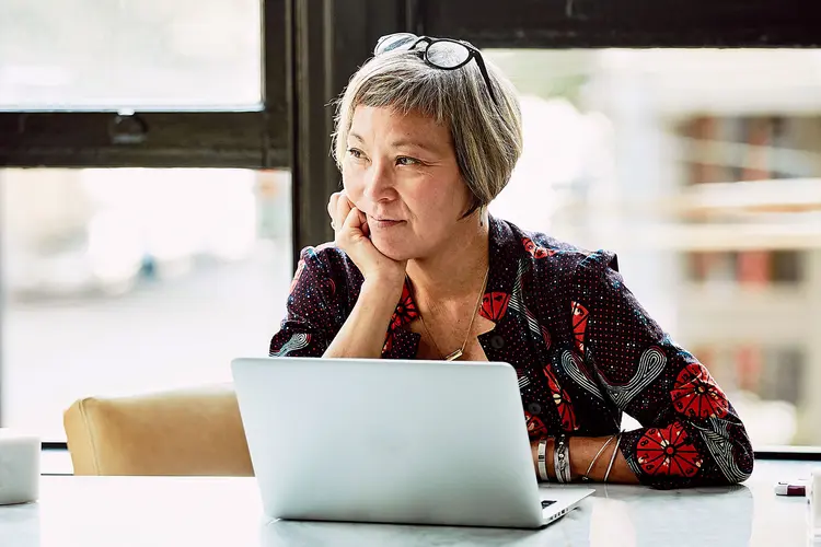 photo of mature woman at computer