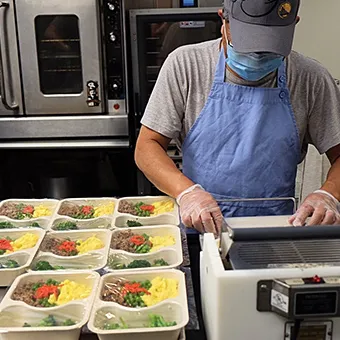 photo of volunteer packing meals