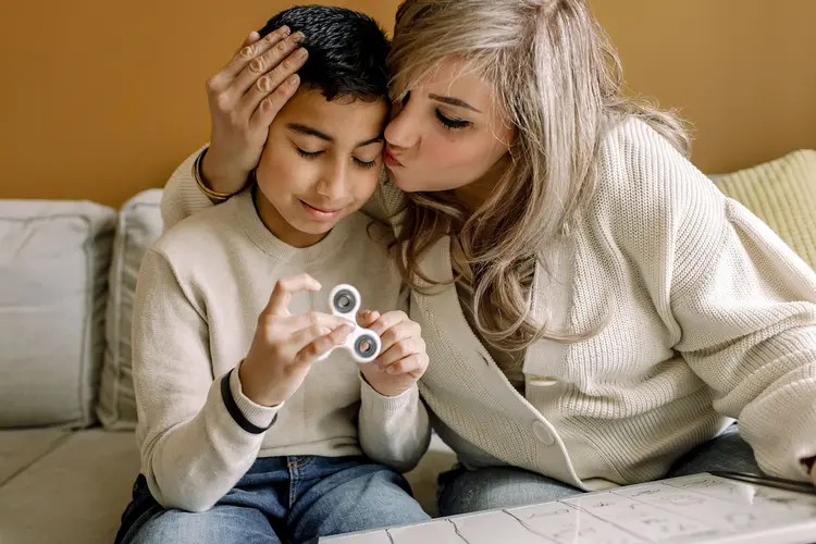 photo of mother kissing son with autism