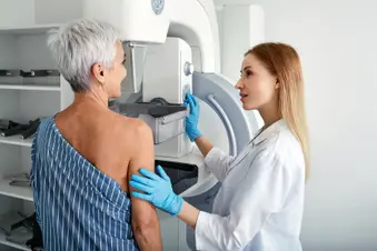photo of senior woman undergoing mammogram scan