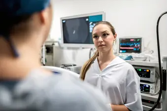 photo of nurse listening to doctor