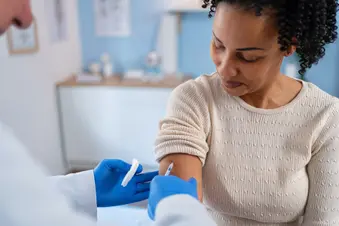 photo of woman getting vaccination