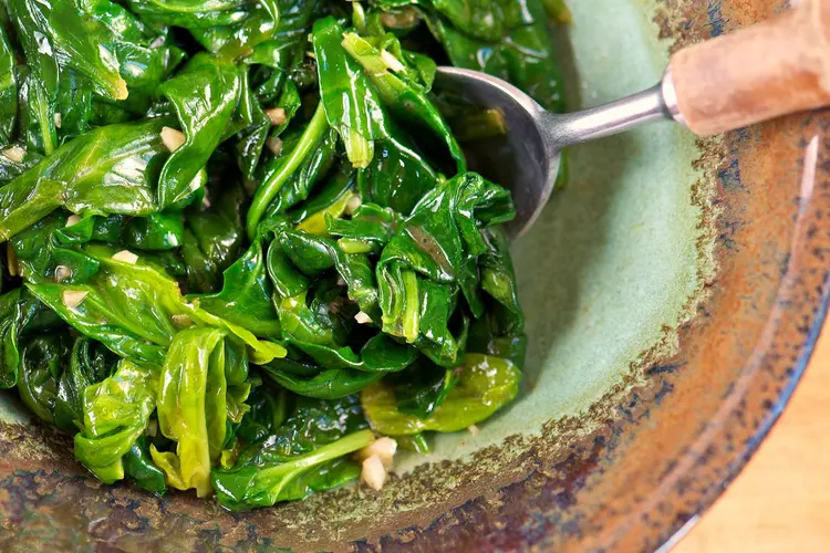 photo of sauteed spinach in pottery bowl