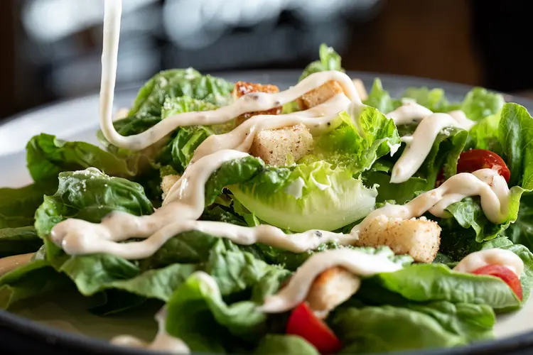 photo of pouring dressing on vegetable salad