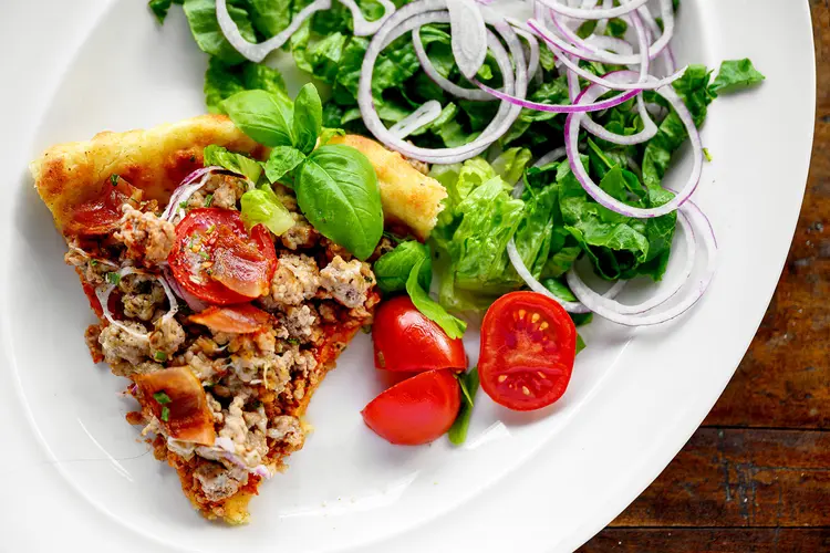 photo of cheeseburger pizza and side salad