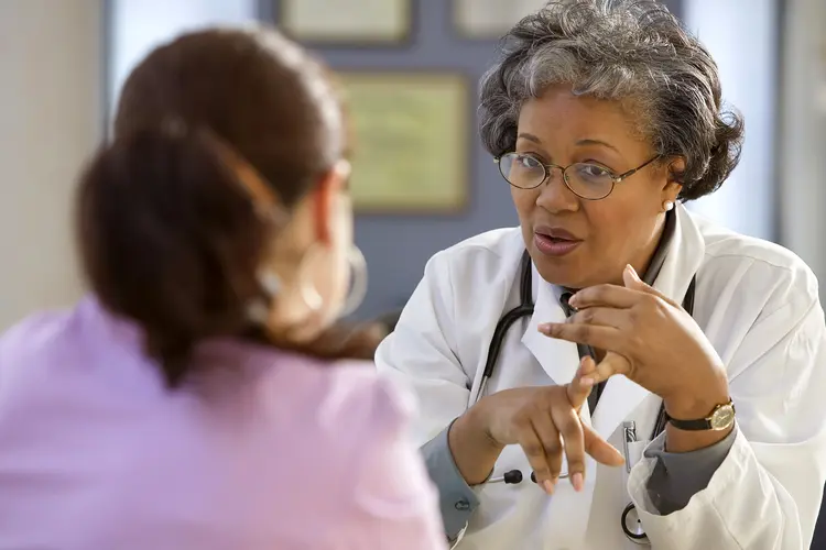 photo of doctor talking with patient