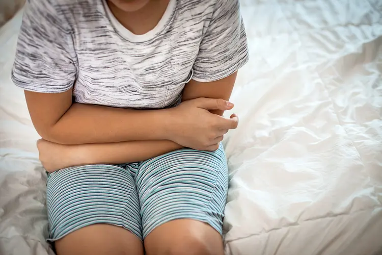photo of young boy with stomach ache