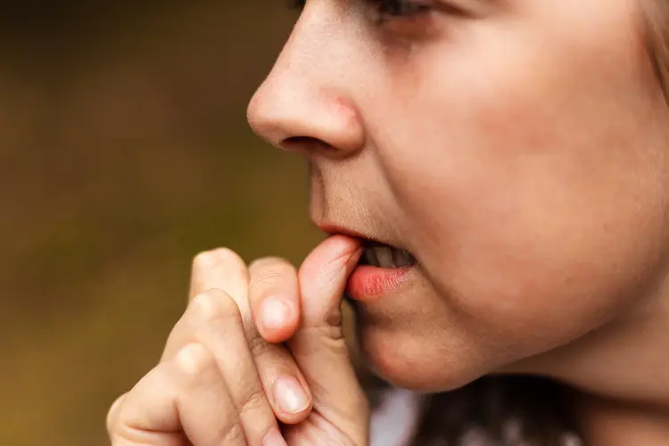Girl showing signs of worry while keeping her thumb between her lips