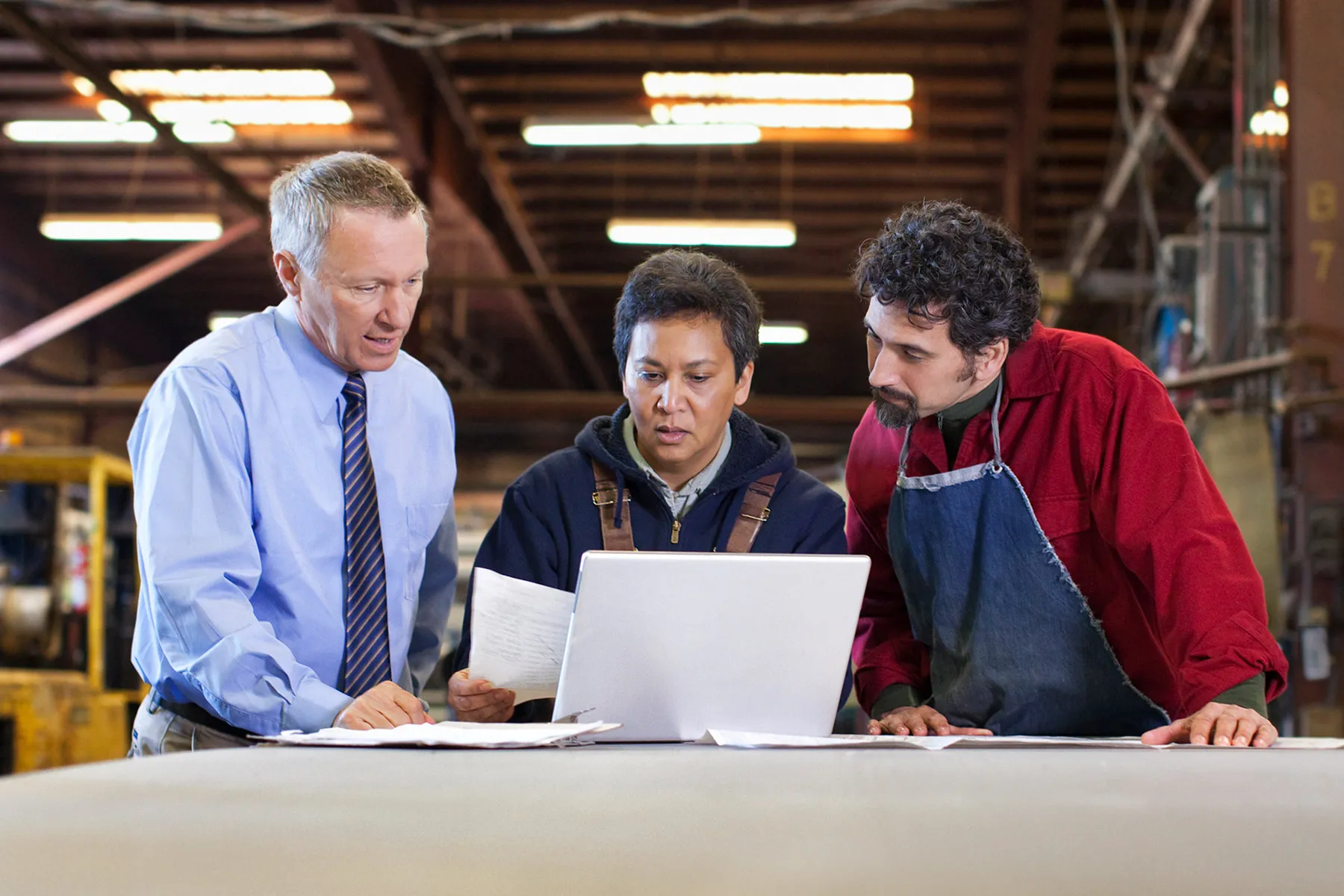 photo of foreman and workers in manufacturing plan