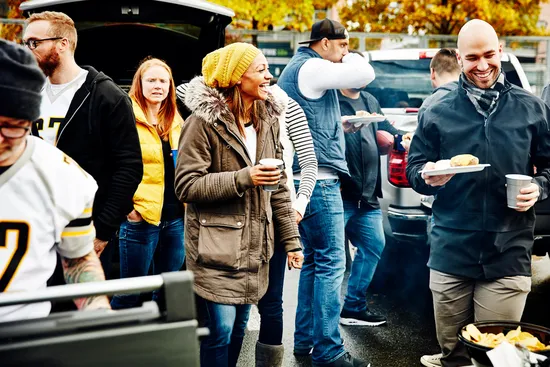 photo of friends tailgating in stadium parking lot