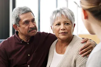 photo of senior couple talking with doctor