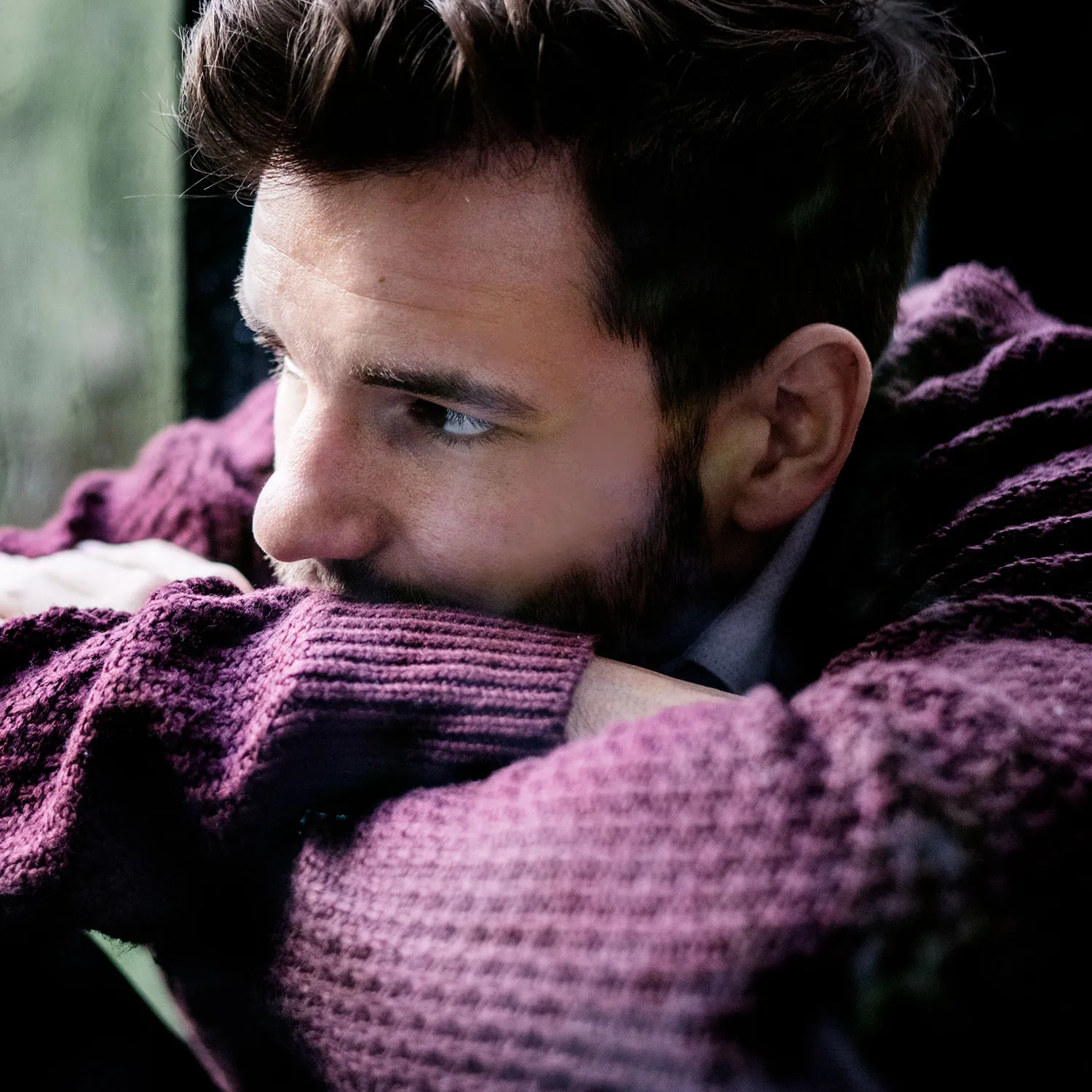 photo of man looking out the window