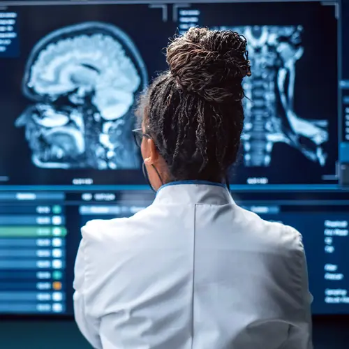 photo of doctor examining cranial MRI scans